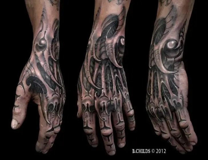 Men's biomechanical hand tattoos